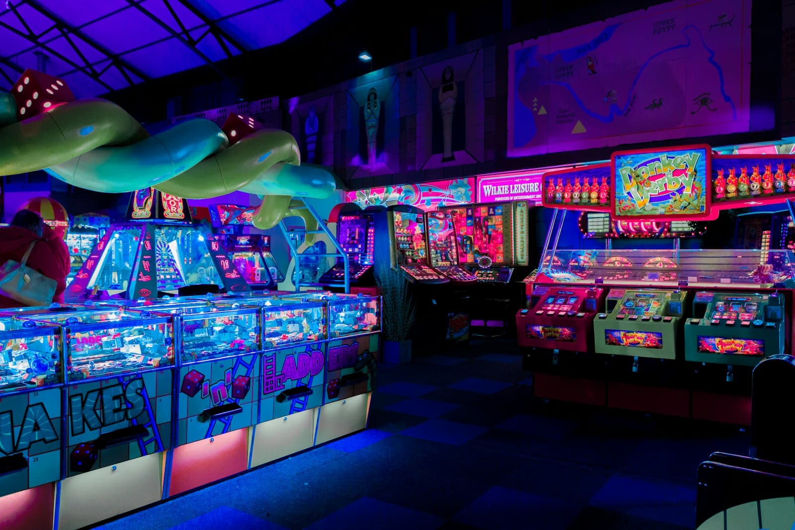 Indoor arcade floor with redemption games and neon lighting