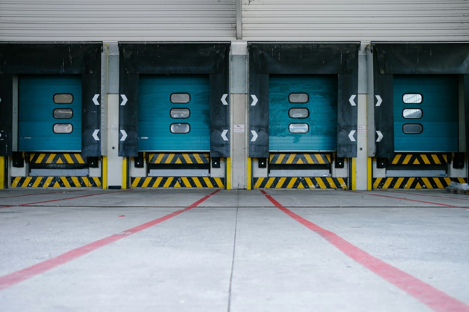 Row of warehouse loading dock doors with painted guide lines