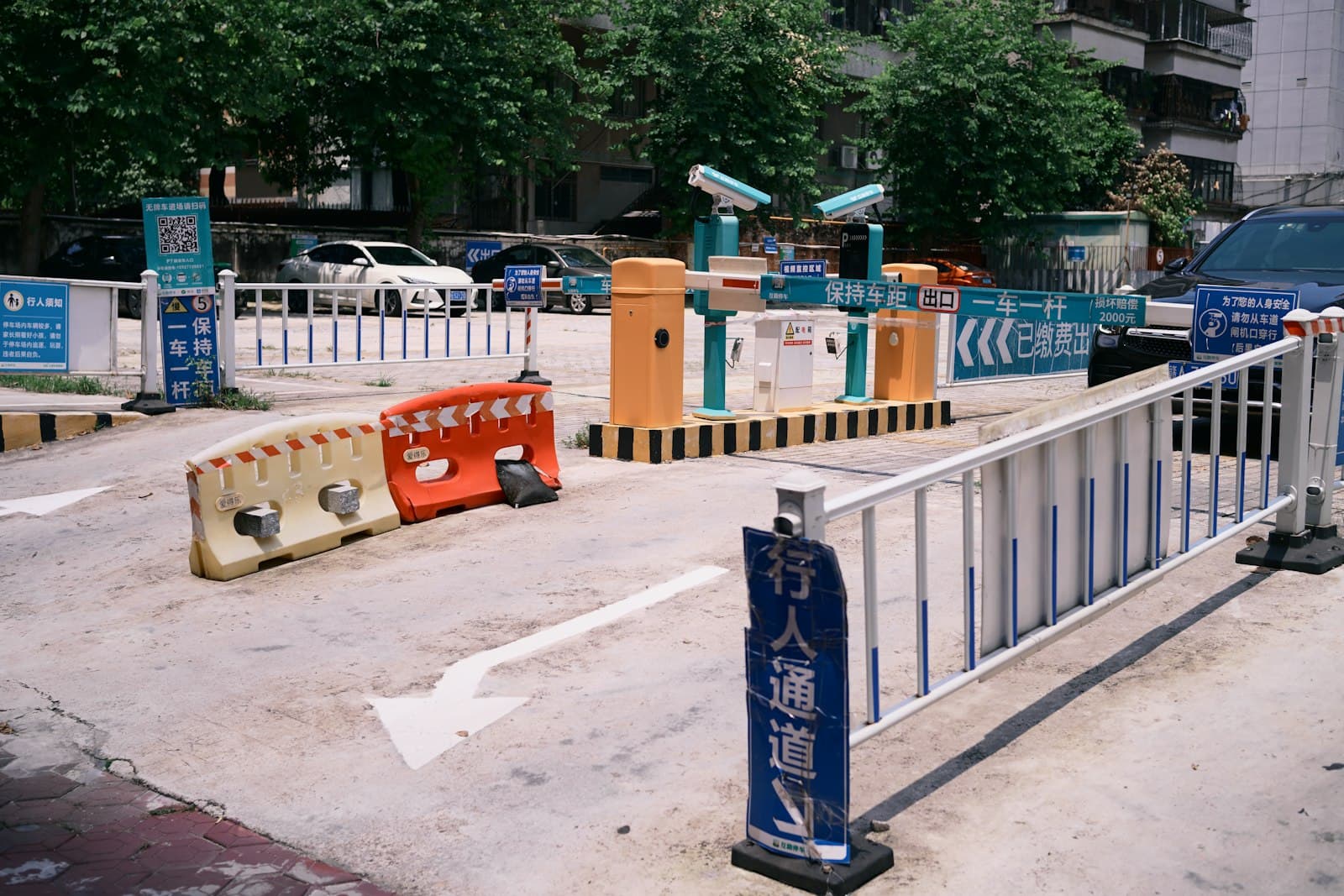 Dual boom gates with overhead cameras covering inbound and outbound lanes