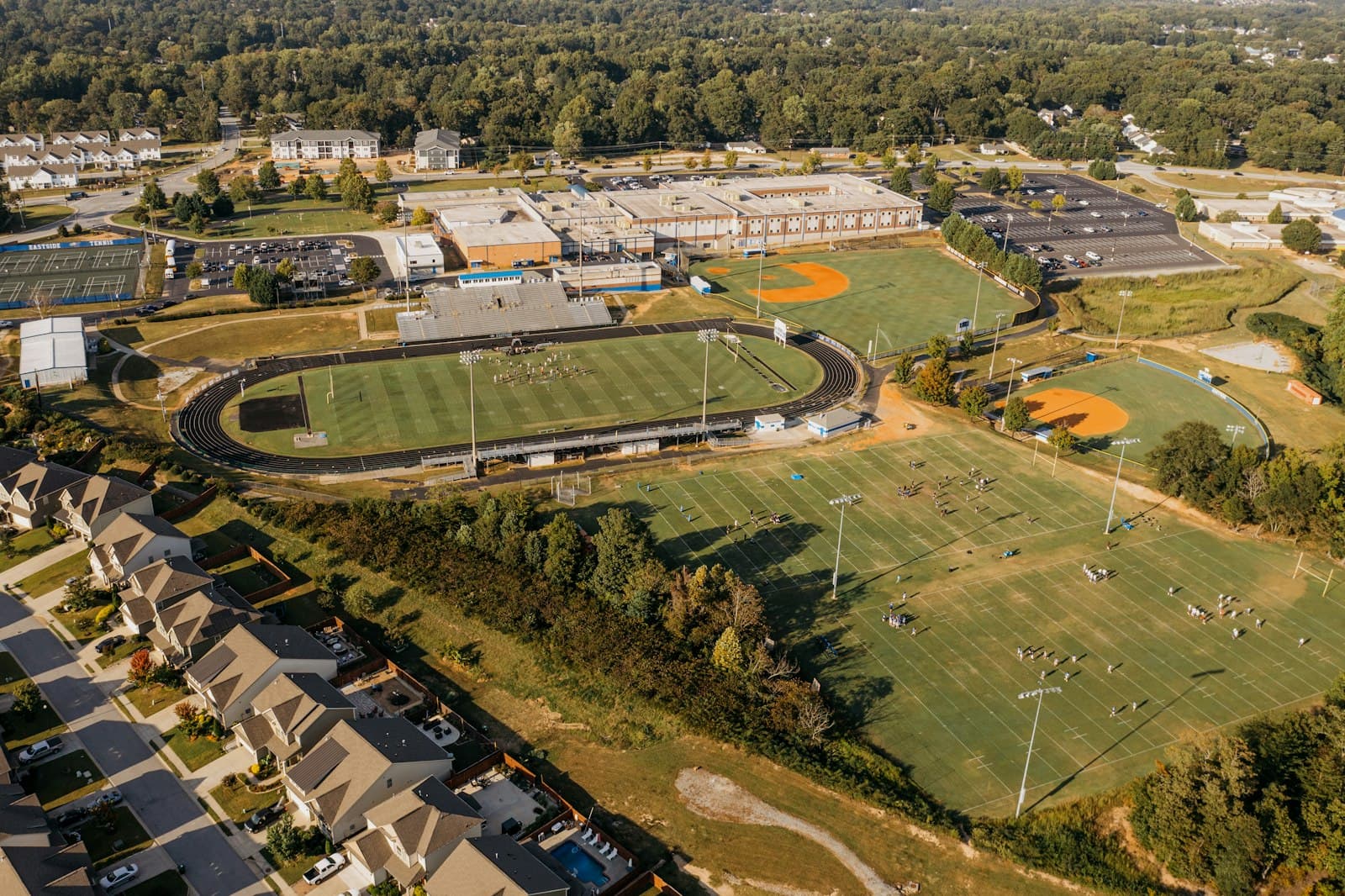 Aerial view of a school campus with parking lot and athletic fields